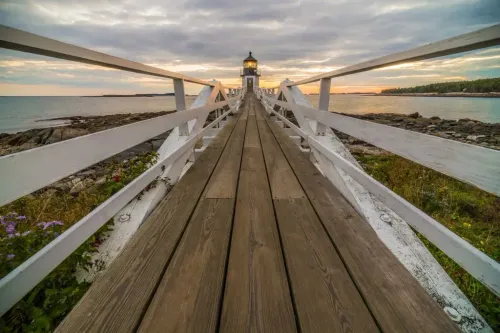 long walk way leading to a lighthouse